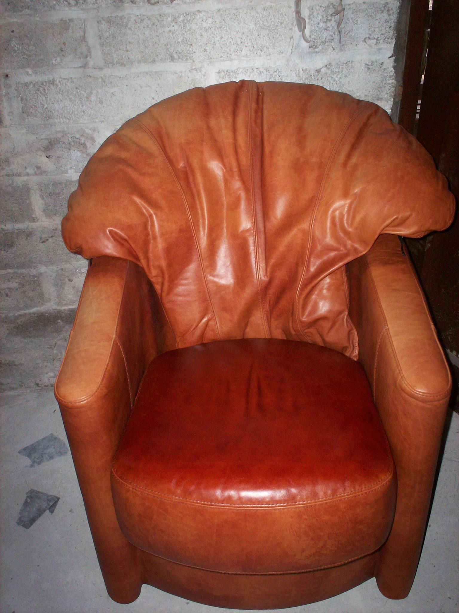 Aged and faded front of tub chair