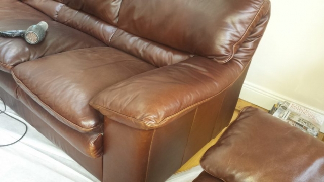 Brown leather sofa arm with colour fading